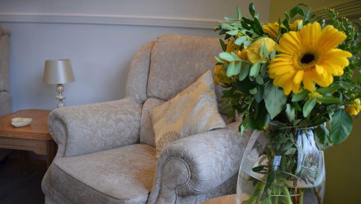 armchair with vase of flowers