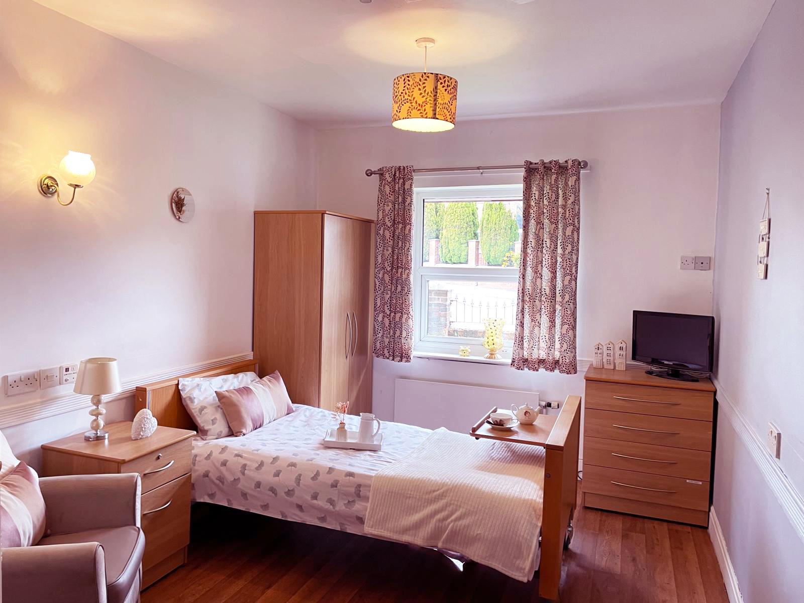 pink care home bedroom with floral curtains